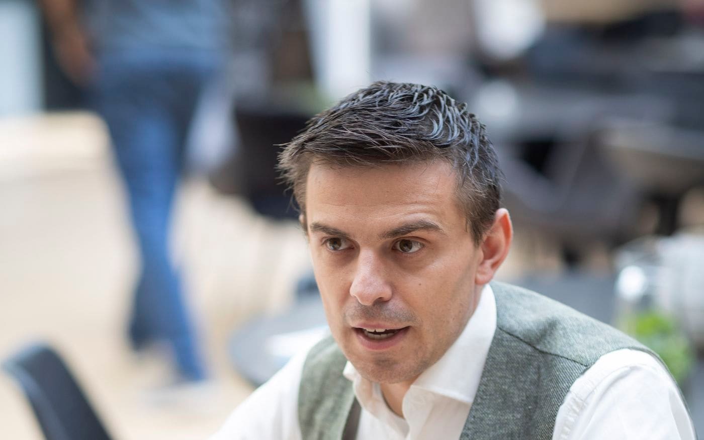 Adviseur leunt over de tafel en legt geconcentreerd iets uit